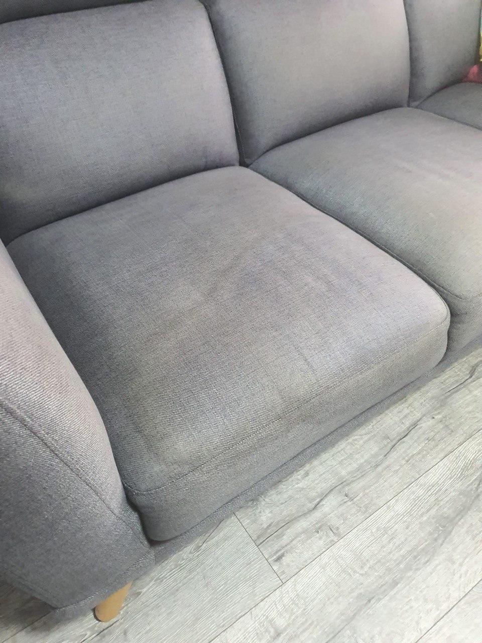 Grey sofa with stain on it